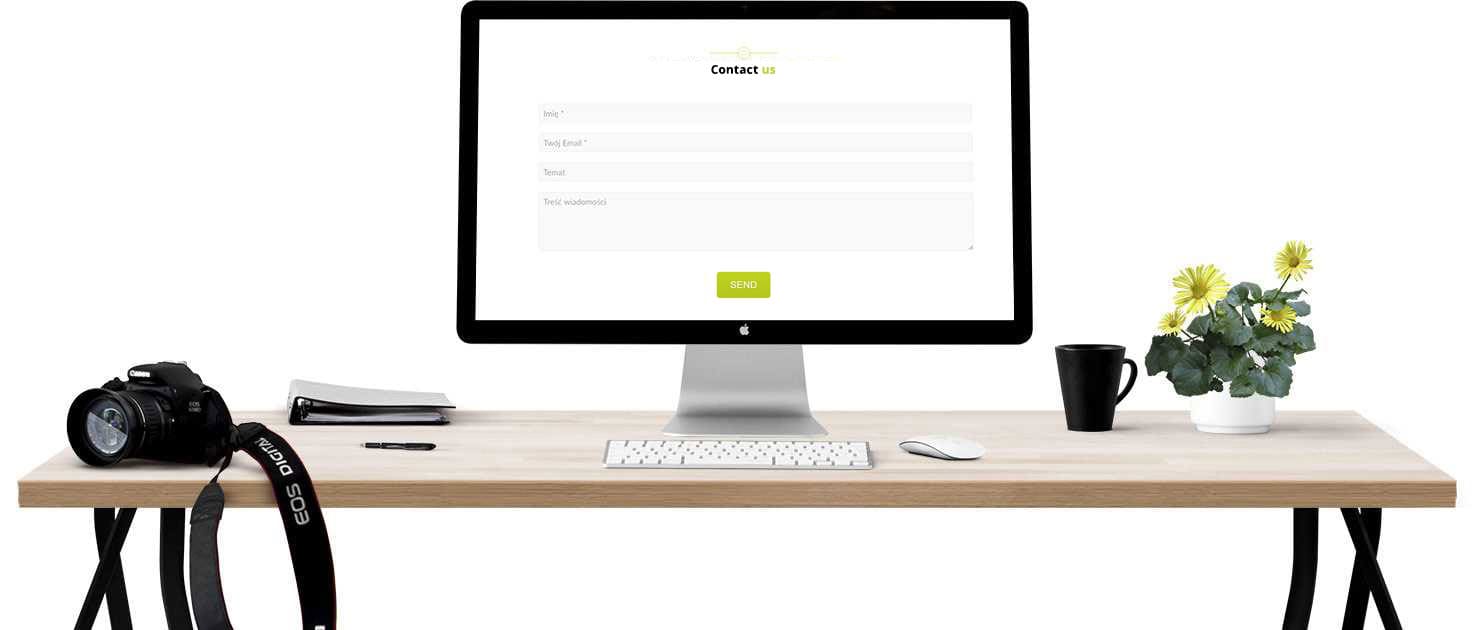 A clean desk with a camera, notebook, pen, and potted flowers. A computer monitor displaying a contact form is at the center. A keyboard, mouse, and mug are also on the desk.